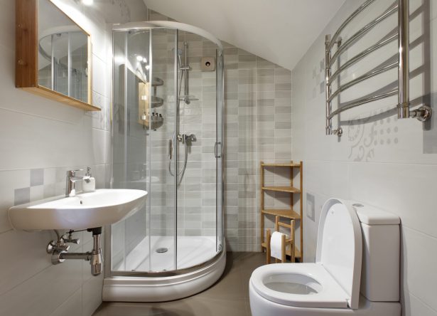 Small bathroom with toilet and shower in gray tones